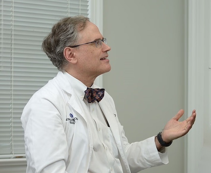 Paul Foster, MD, in conversation in a clinical setting