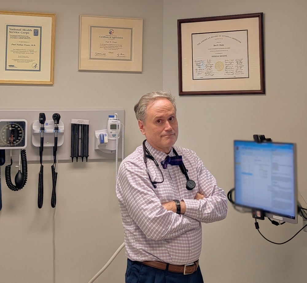Paul Foster, MD, in his exam room — stethoscope and credentials visible
